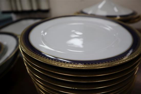 A German part dinner service by F. A. Schumann, blue-bordered and heightened in gilt (22 pieces)